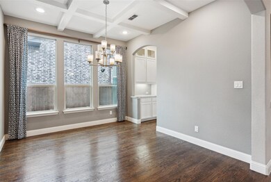 Unfurnished dining area featuring coffered ceiling, beam ceiling, dark hardwood / wood-style flooring, and a notable chandelier