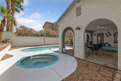 View of swimming pool with an in-ground hot tub, a