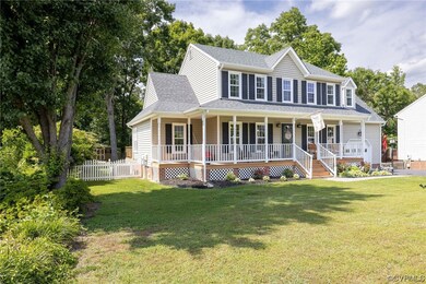 View of front facade with a front yard and covered
