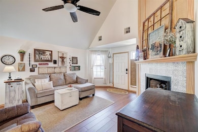 Living room featuring high vaulted ceiling, hardwo