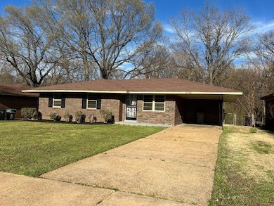Single story home featuring an attached carport, a