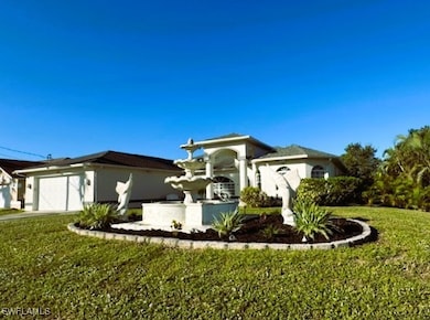 View of front of home with a front yard and a gara