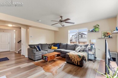 Living room with ceiling fan and low maintenance l