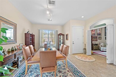 Dining area with light tile patterned floors, visi
