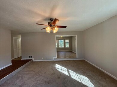 Carpeted empty room featuring a textured ceiling a