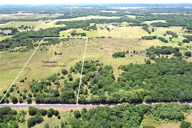 Aerial view of sparsely populated area featuring property parcel outlined