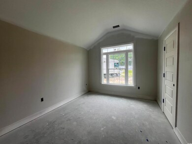Bonus room featuring lofted ceiling and baseboards
