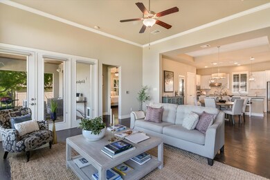 Living area with french doors, ceiling fan with n