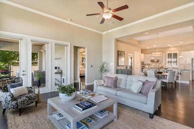 Living area with french doors, ceiling fan with n