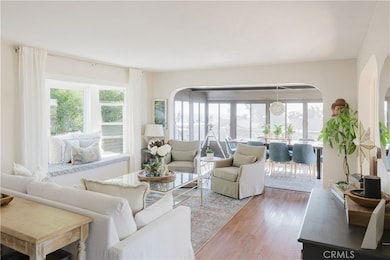 Enter the home with it's ample windows and fresh decor. This is one of two living spaces.