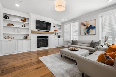 Living room featuring a fireplace, wood finished f