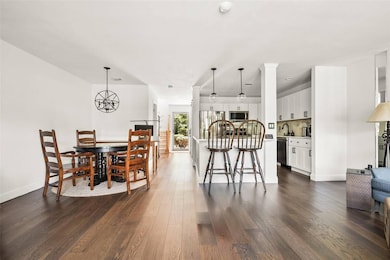 Dining area featuring dark wood finished floors and a chandelier