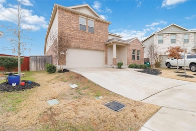 Traditional-style home with driveway, fence, bric
