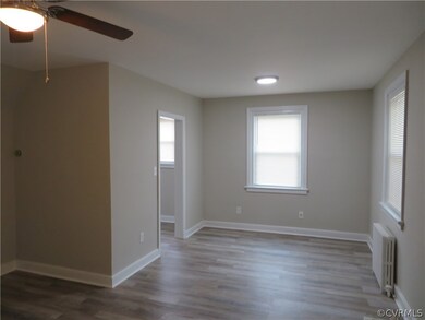 Unfurnished room featuring ceiling fan, radiator h