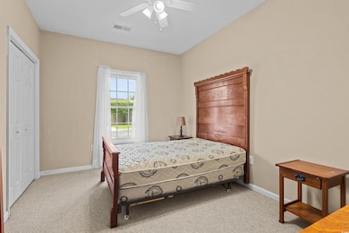 Bedroom with carpet flooring, baseboards, and ceiling fan