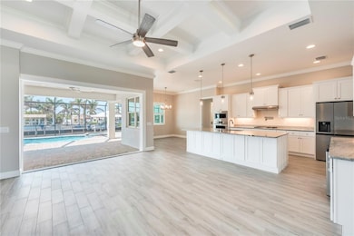 Living/ kitchen pool and waterfront view, coffered ceiling