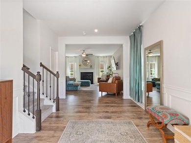 Foyer entrance featuring ceiling fan, wood finishe