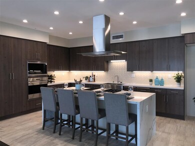 Large kitchen island with waterfall edge quartz an