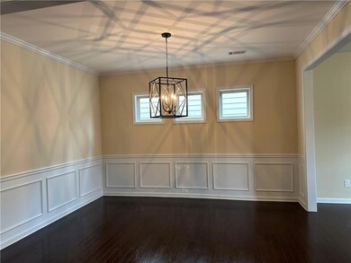 Empty room featuring dark wood-style flooring, a n