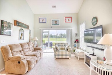 Living room featuring high vaulted ceiling and lig