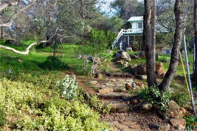 Native rock path leading to garage and bonus room/