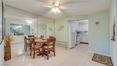 Tiled dining space with lofted ceiling, a textured