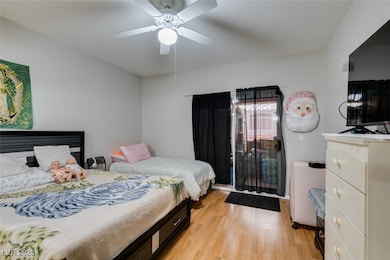 Bedroom with light wood finished floors and ceilin