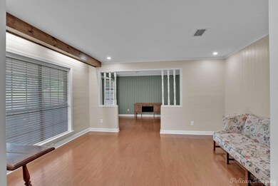 Living area with wood-type flooring, beam ceiling,