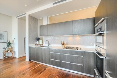 Kitchen featuring gray cabinets, tasteful backspl