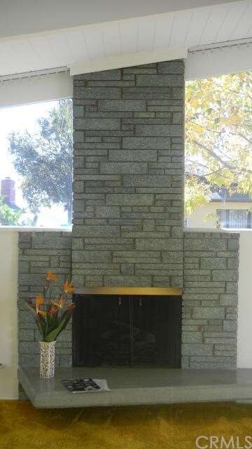 Dramatic stone fireplace, high ceilings, angular w