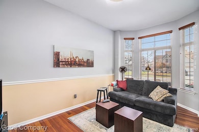 Living area with wood finished floors and baseboards