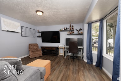 Office featuring a textured ceiling and wood finished floors