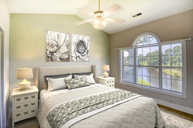 Bedroom featuring ceiling fan, vaulted ceiling, an
