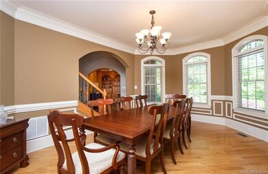 Formal dining room with arched windows, hardwood f