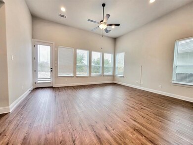 Empty room featuring healthy amount of natural light, light wood-style floors, ceiling fan, and recessed lighting