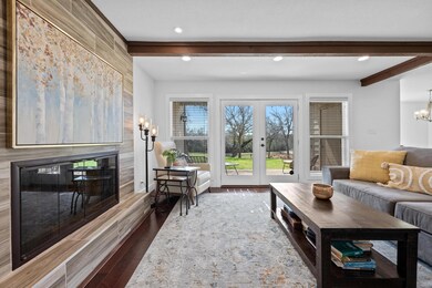 Living room with dark wood finished floors, a cha