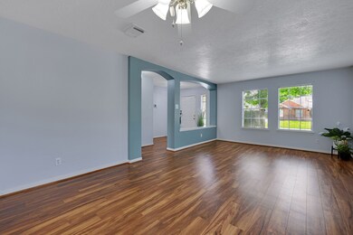 Bright and spacious living area with wood look flo