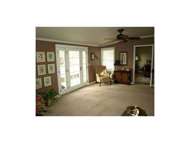 Sitting area adjoins family room with entry to bac