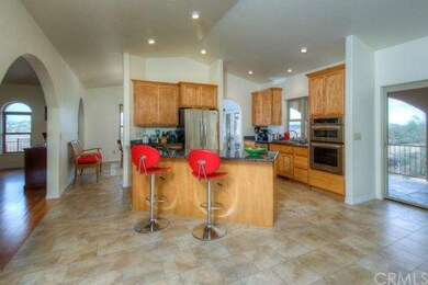 Large entertainer's kitchen with archways into liv