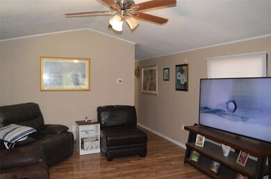 Living room featuring ornamental molding, lofted c