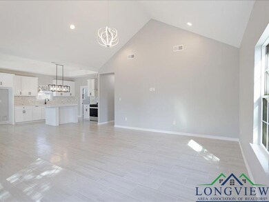 Unfurnished living room featuring high vaulted cei