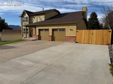 View of home's exterior with driveway, a chimney, 