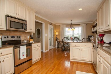 Kichen also has tile backsplash, stainless steel appliances and hardwood Floors