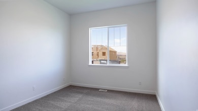 Carpeted empty room featuring baseboards