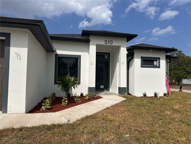 View of exterior entry with stucco siding and a la
