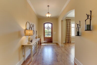 Hardwood Floors, Crown Molding, Arched Doorways  .