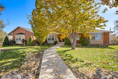 Obstructed view of property featuring brick siding and a front yard