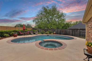 Custom heated pool and patio at twilight