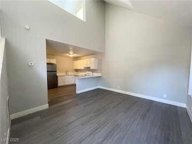 Unfurnished living room featuring dark wood finish
