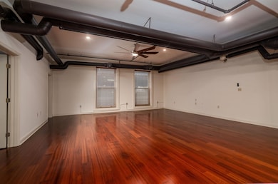 Garage with baseboards and ceiling fan